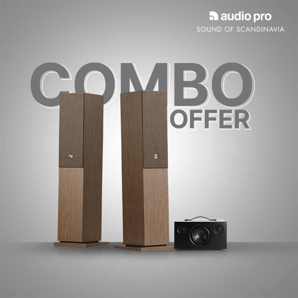 Two tall floorstanding speakers with a wood-grain lower section and fabric upper section, shown alongside a small black projector on a gray gradient background with 'COMBO OFFER' and 'audio pro SOUND OF SCANDINAVIA' text.